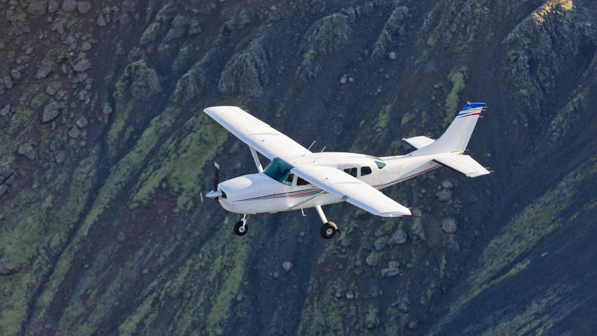 Flying low over moss covered mountains, South Coast, Iceland