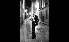 Helmut Newton black and white photograph of woman in black suit