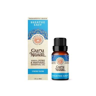 A bottle of GuruNanda essential oil with a blue box