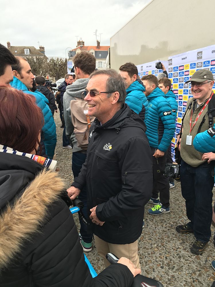 Bernard Hinault smiling with the riders at the Paris-Roubaix team presentation