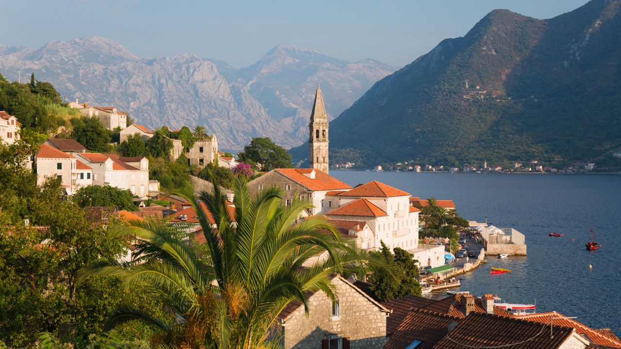 Buildings with orange roofs along the coastline of Perast, Montenegro