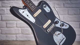 A Fender Johnny Marr Jaguar leaning against a white wall