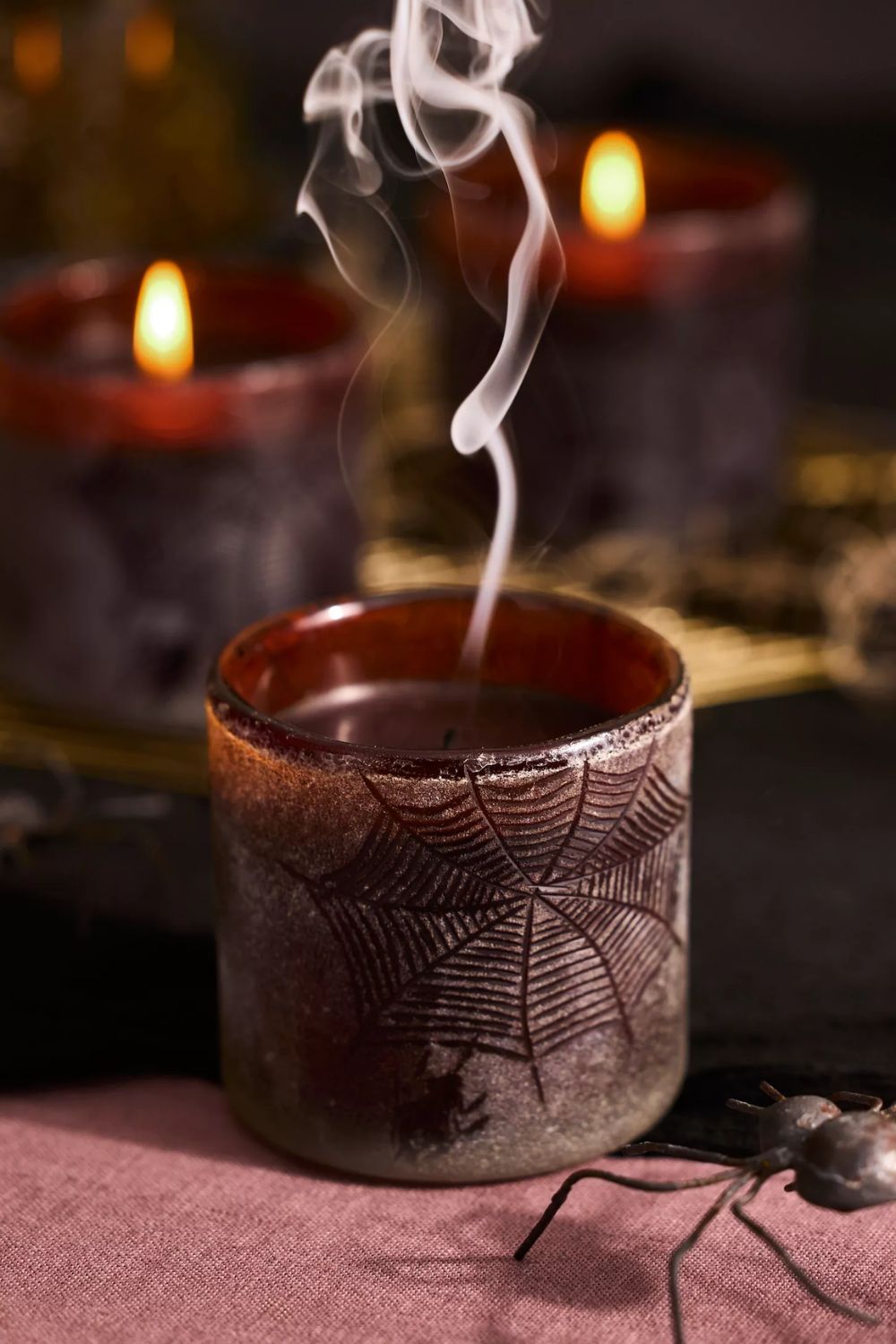 Frosted burgundy candle with etched spiderweb design