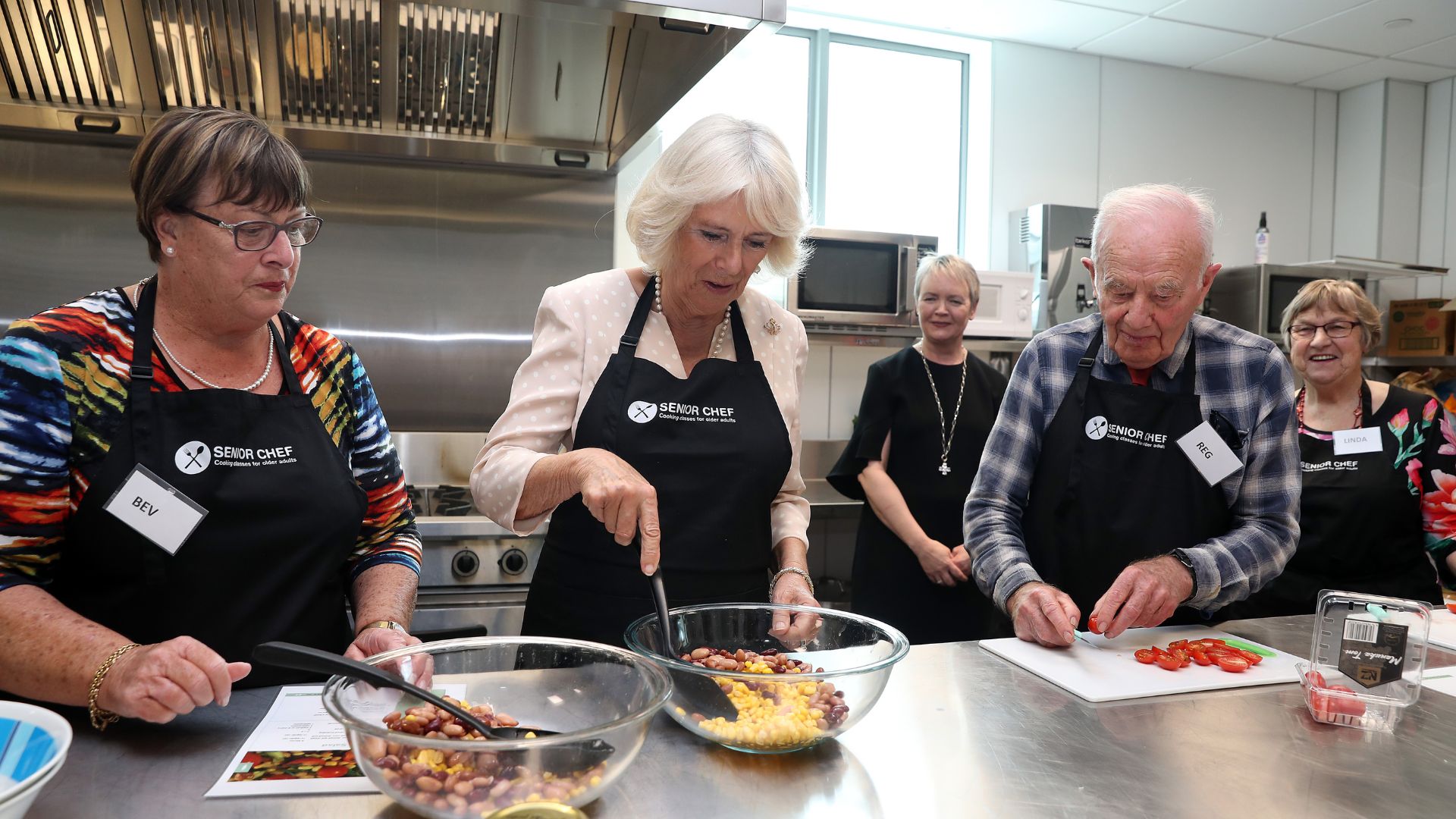 Queen Camilla taking part in a cooking class during her 2019 visit to New Zealand