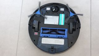 Eufy Robovac 15C Max updaide down on a tiled floor