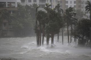 Water flowing out of the Miami River floods a walkway as Hurricane Irma passes through on Sept. 10, 2017, in Miami, Florida. 