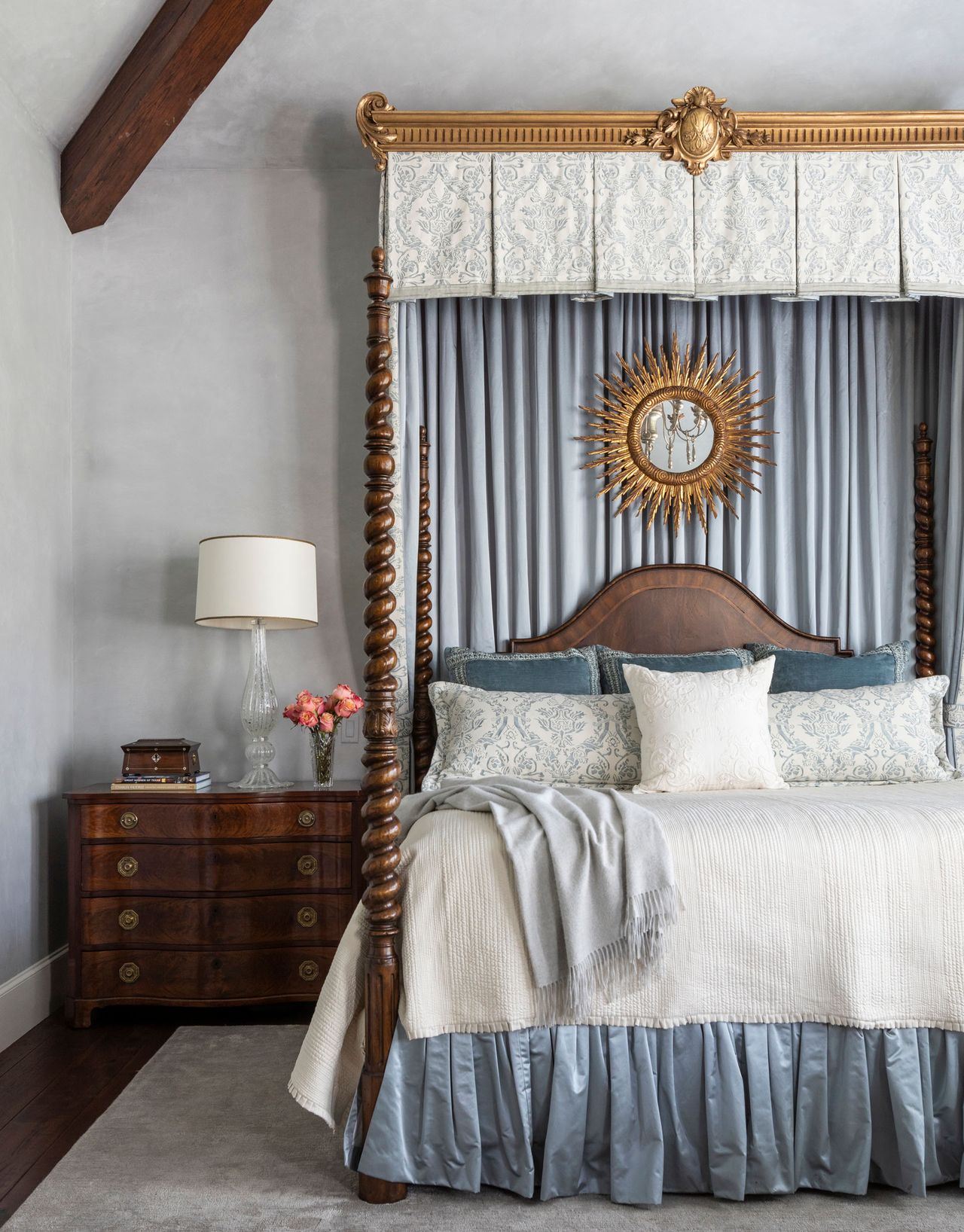 Traditional four post bed with gold sunshine mirror