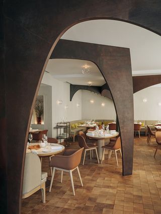 A mixture of different seating and table options at Nomicos, Paris, France