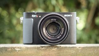 Sony RX1R III on a wooden surface in a woodland environment
