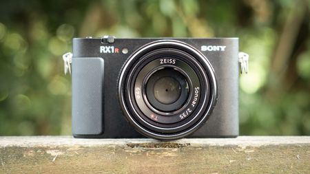 Sony RX1R III on a wooden surface in a woodland environment