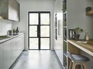 small kitchen with white light and timber color scheme by Roundhouse