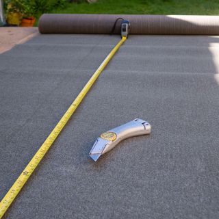 Shed roof felt being prepared for fitting to a residential garden shed