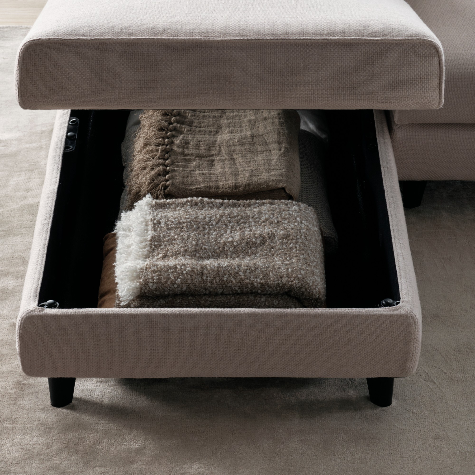 A close-up of the built-in storage space inside King Living&#039;s Delta sofa