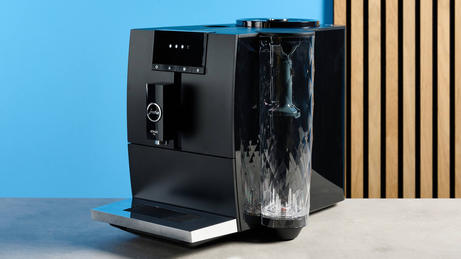 the jura ena 4 automatic coffee machine in piano black with a faceted water tank and bright screen