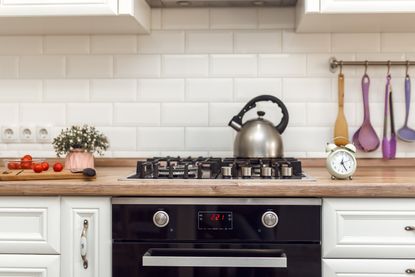 A kitchen with a tea kettle on the stove