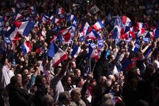 Marine Le Pen supporters wave French flags.