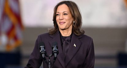 Kamala Harris speaks at Howard University wearing a purple suit with a satin blouse and an American flag pin