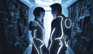 Tron: Legacy Quorra and Sam talking in a dimly lit corridor
