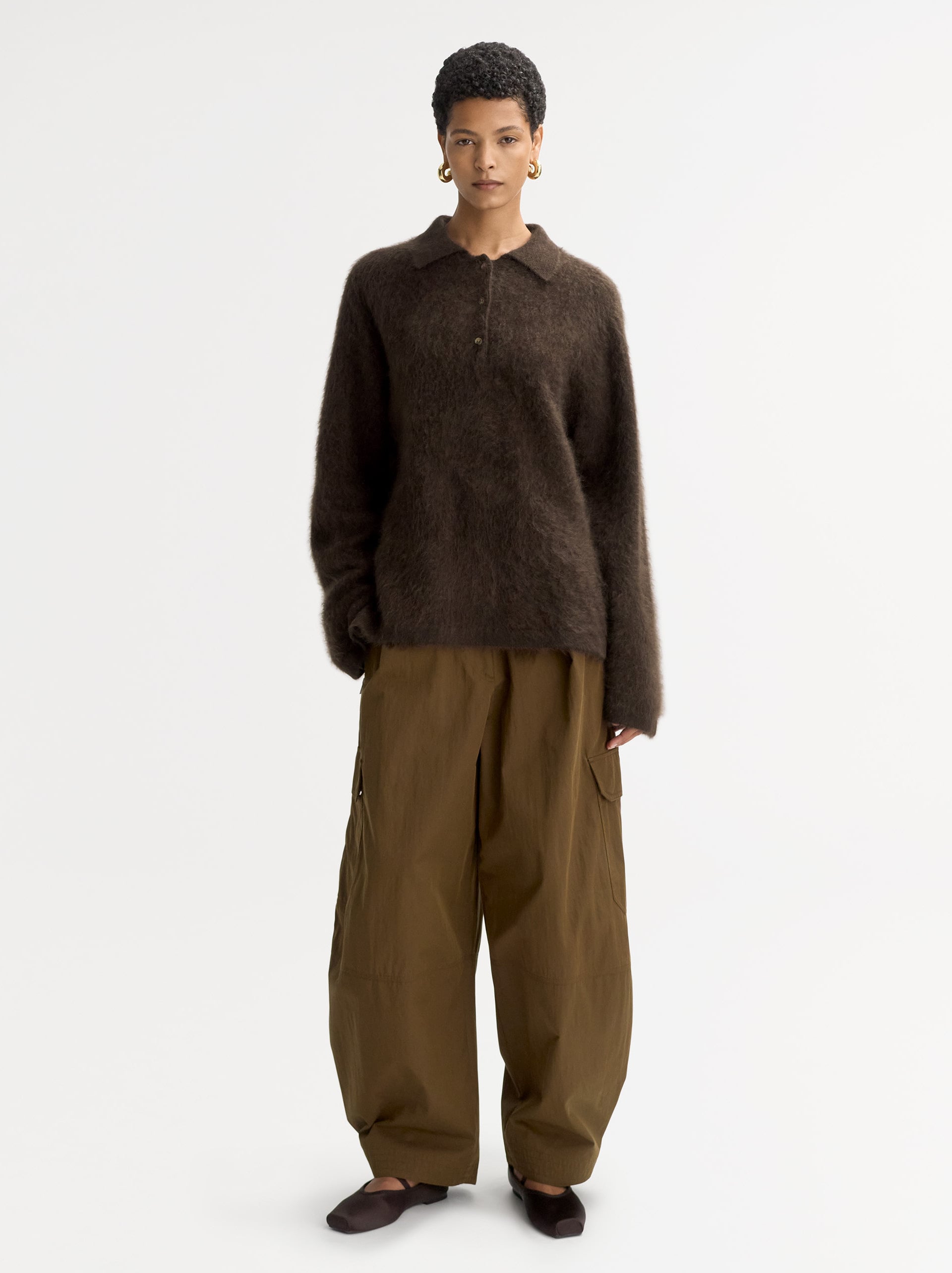 a model wearing a brushed cashmere polo neck jumper from soft goat