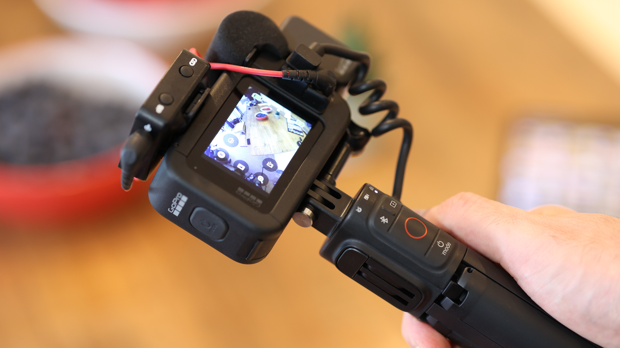 A hand holding the GoPro Volta tripod grip