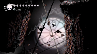 Screenshot from fan-made mod Hollow Knight: The Sanctuary, showing our bug protag falling through a level with chains and bats in the background.