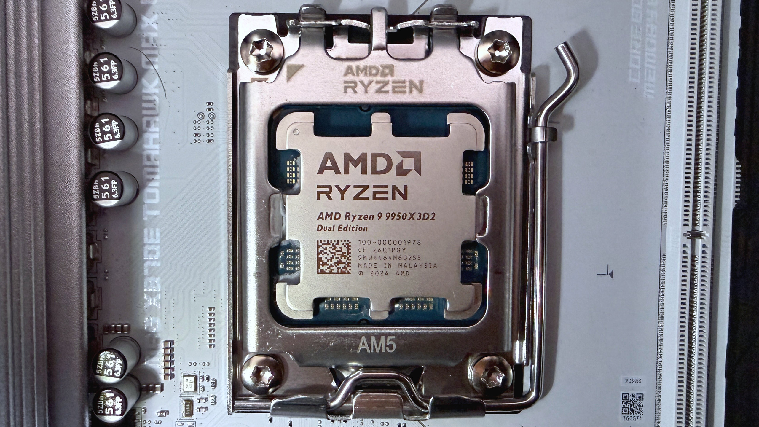A photo of an AMD Ryzen 9 9950X3D2 Dual Edition processor mounted in a motherboard CPU socket