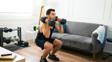 Man performing weighted squats