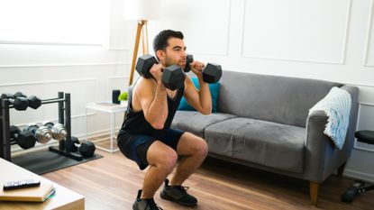 Man performing weighted squats