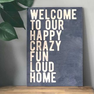 Welcome wall art to style a guest bedroom for Christmas
