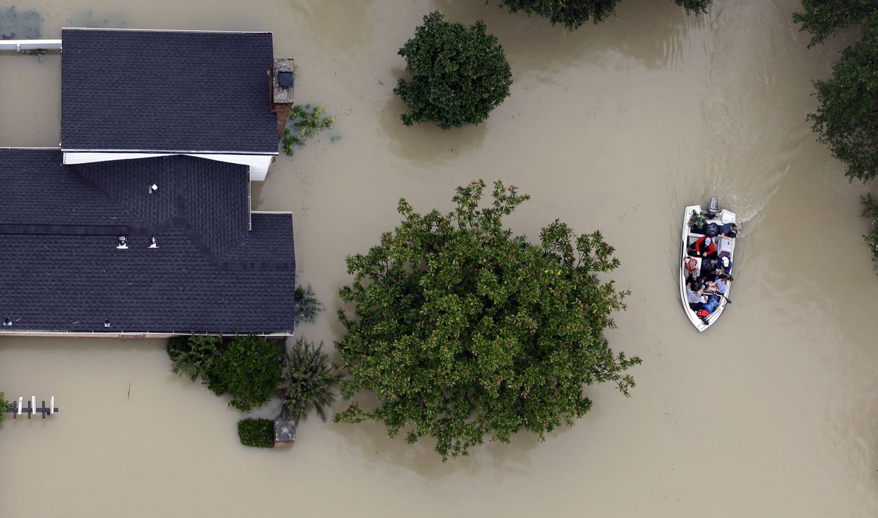 Houston residents evacuate their homes as floodwaters from Tropical Storm Harvey rise.