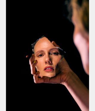 woman looking in mirror, as Photo 2024 preview