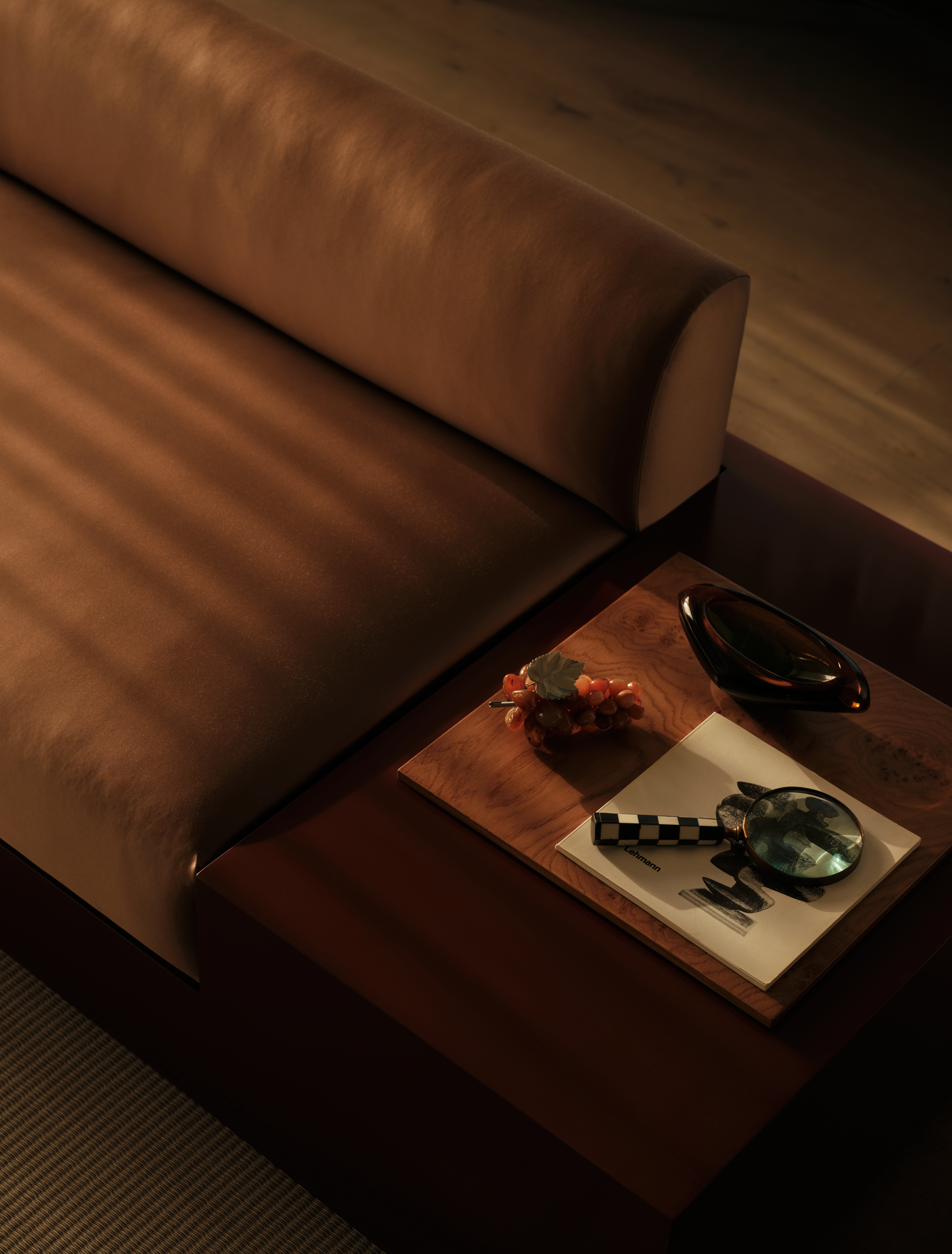 view of the Penthouse at The Founding by Conran and Partners, including timber based furniture and warm colours under moody lighting