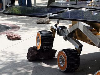 JPL scientists demonstrate the rover's obstacle climbing ability. Sensors detect an obstacle and raise the wheels.