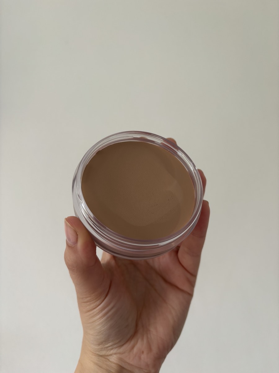 Mica Ricketts holding Vieve cream bronzer for base bronzing