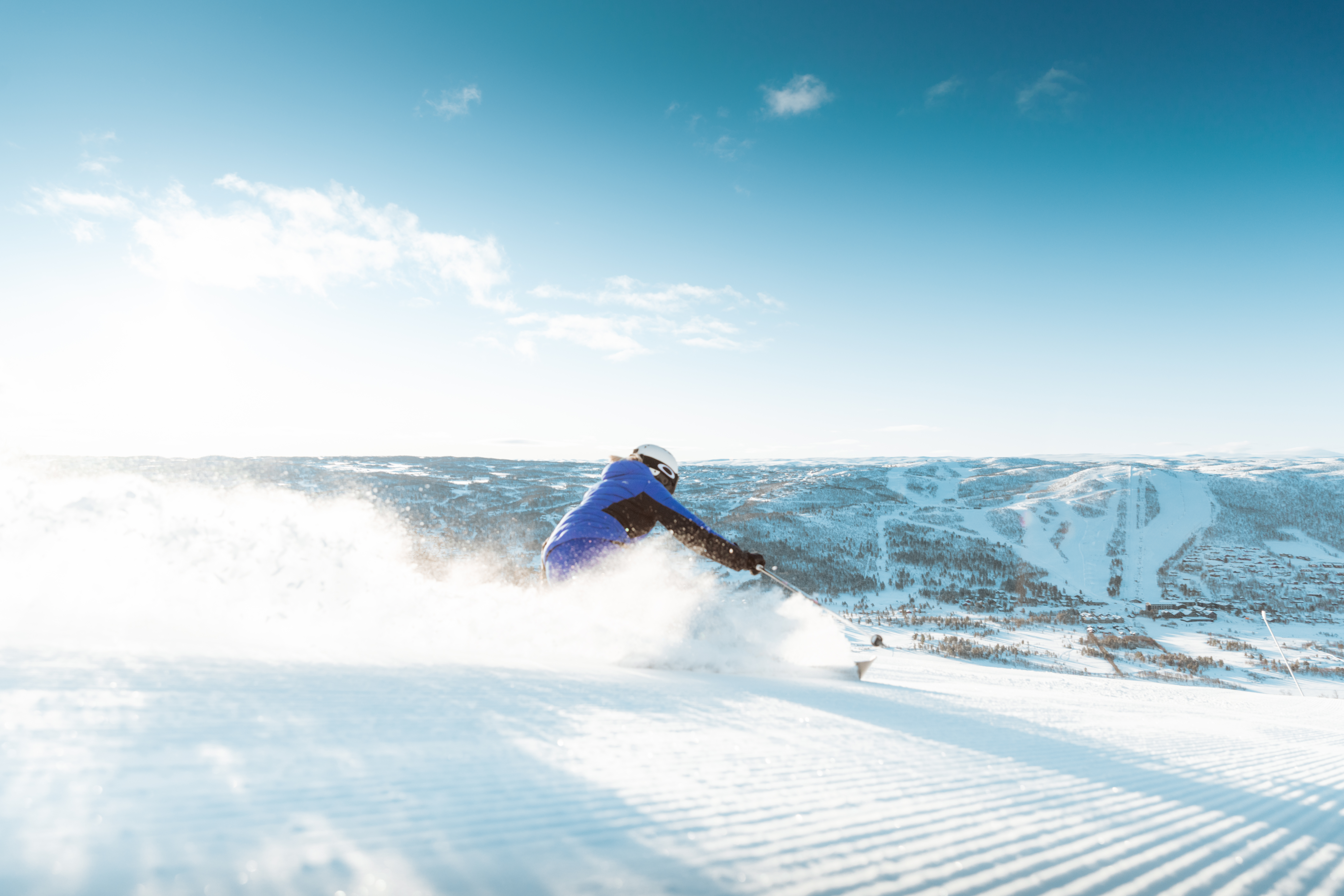 A skiier carves on the piste in Geilo