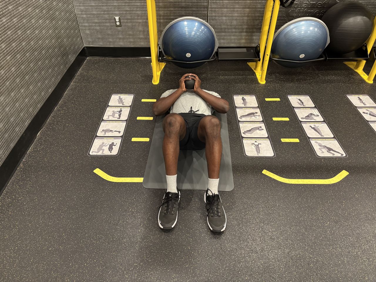 Man exercises with kettlebell in gym