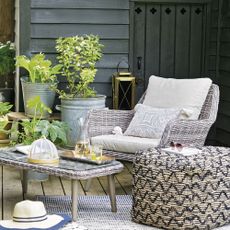 garden with sofa chair potted plant grey door