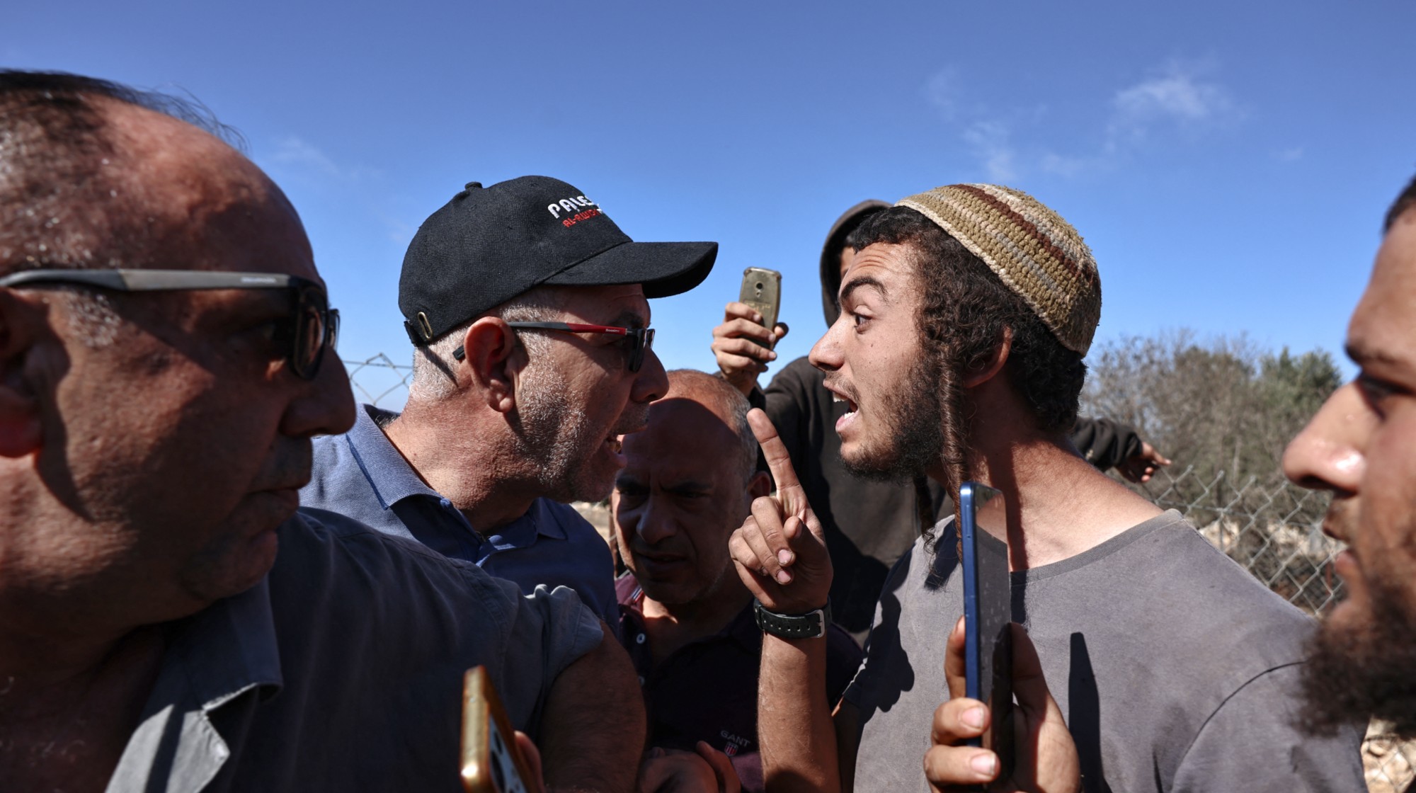 Palestinian farmers (L) scuffle with Israeli settlers during the olive harvest in the Palestinian village of Silwad, near Ramallah in the Israeli-occupied West Bank, on October 29, 2025.