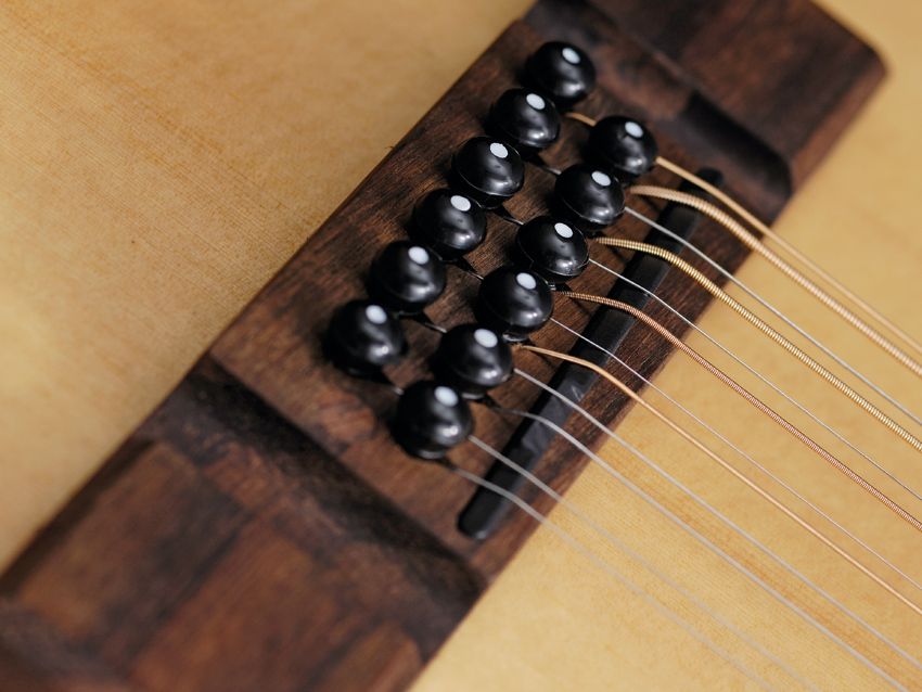 The VE8000PB-12's dedicated 12-string bridge design is reinforced for extra strength.