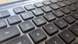 The JLab Epic Wireless Keyboard photographed on a wooden desk.