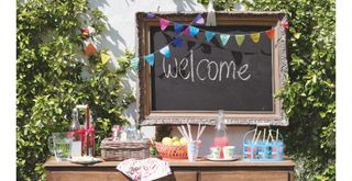 garden party table with welcome sign