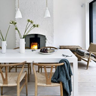 dining room with white walls and wooden chairs