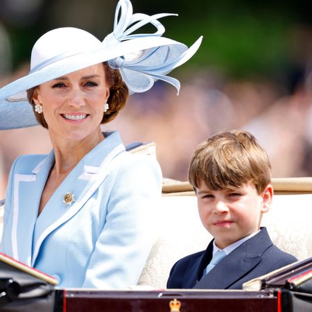 Prince Louis wears a navy blazer with gold buttons and a white shirt with a baby blue tie, which matched brother Prince George and mom Princess Kate's Trooping the Colour outfits