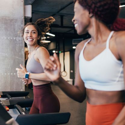 Two women doing one of the best treadmill workouts in the gym