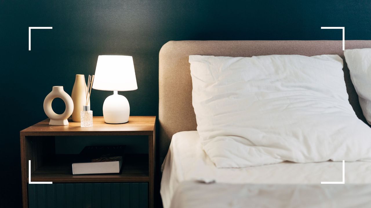 picture of bed with side table and blue statement wall 