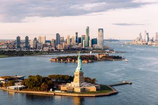 Statue of Liberty and Jersey City skyline seen from helicopter, New York City, USA