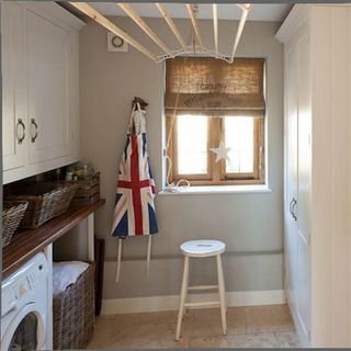 small white utility room with traditional clothes hanger