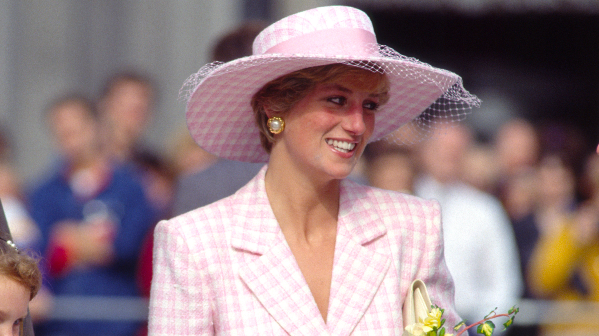 Princess Diana wearing a pink checked Armani suit and hat