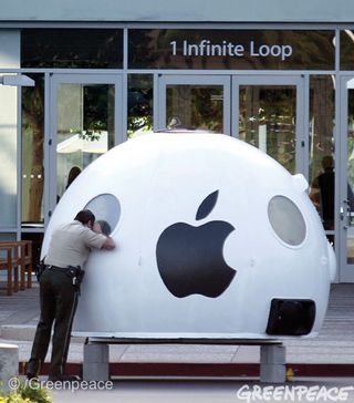 A security guard tries to get a peek inside the Greenpeace iPod