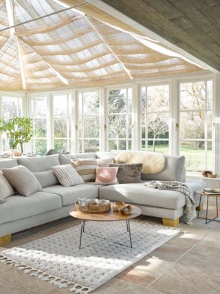 A large sofa in a modern conservatory